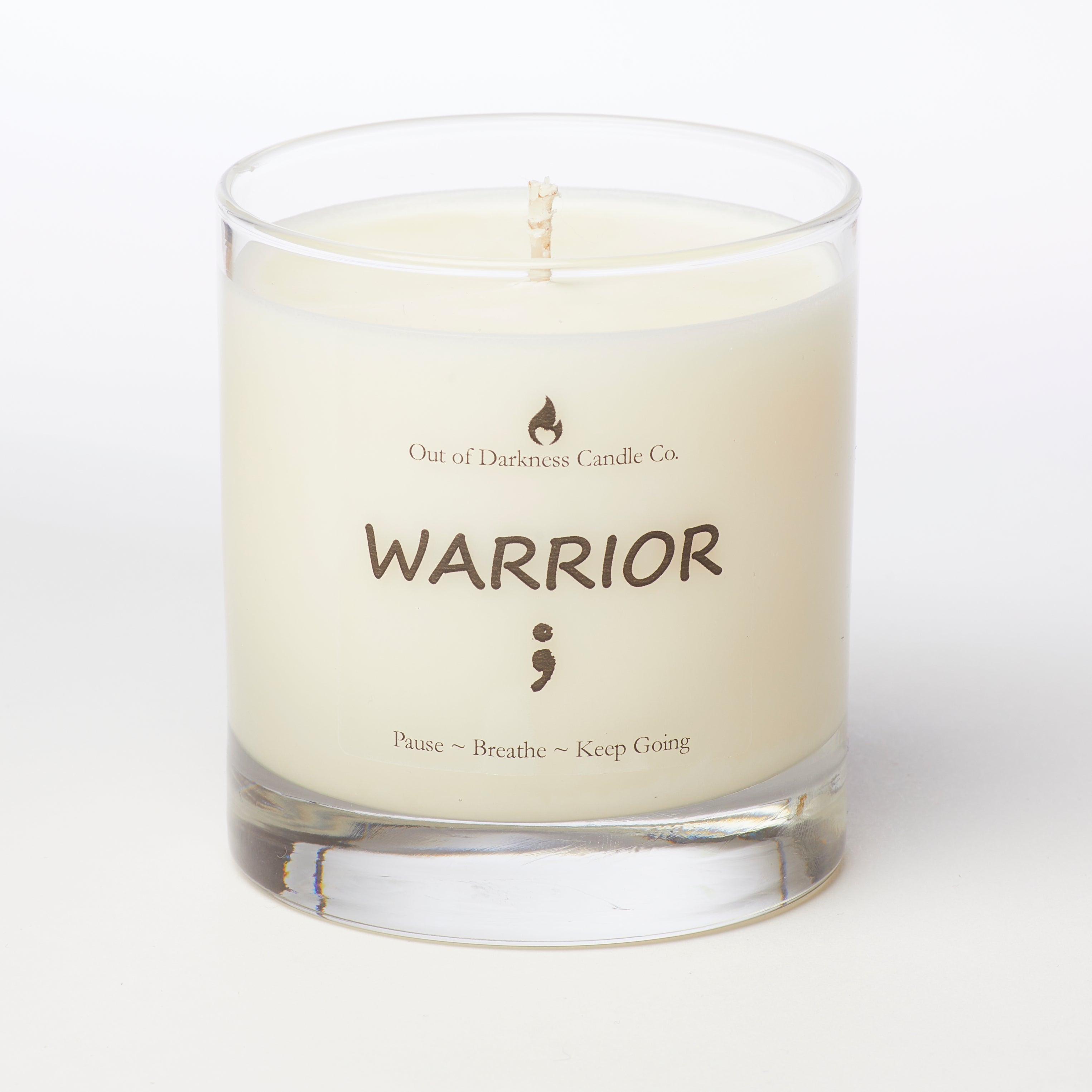 glass jar candle says warrior with semi colon underneath