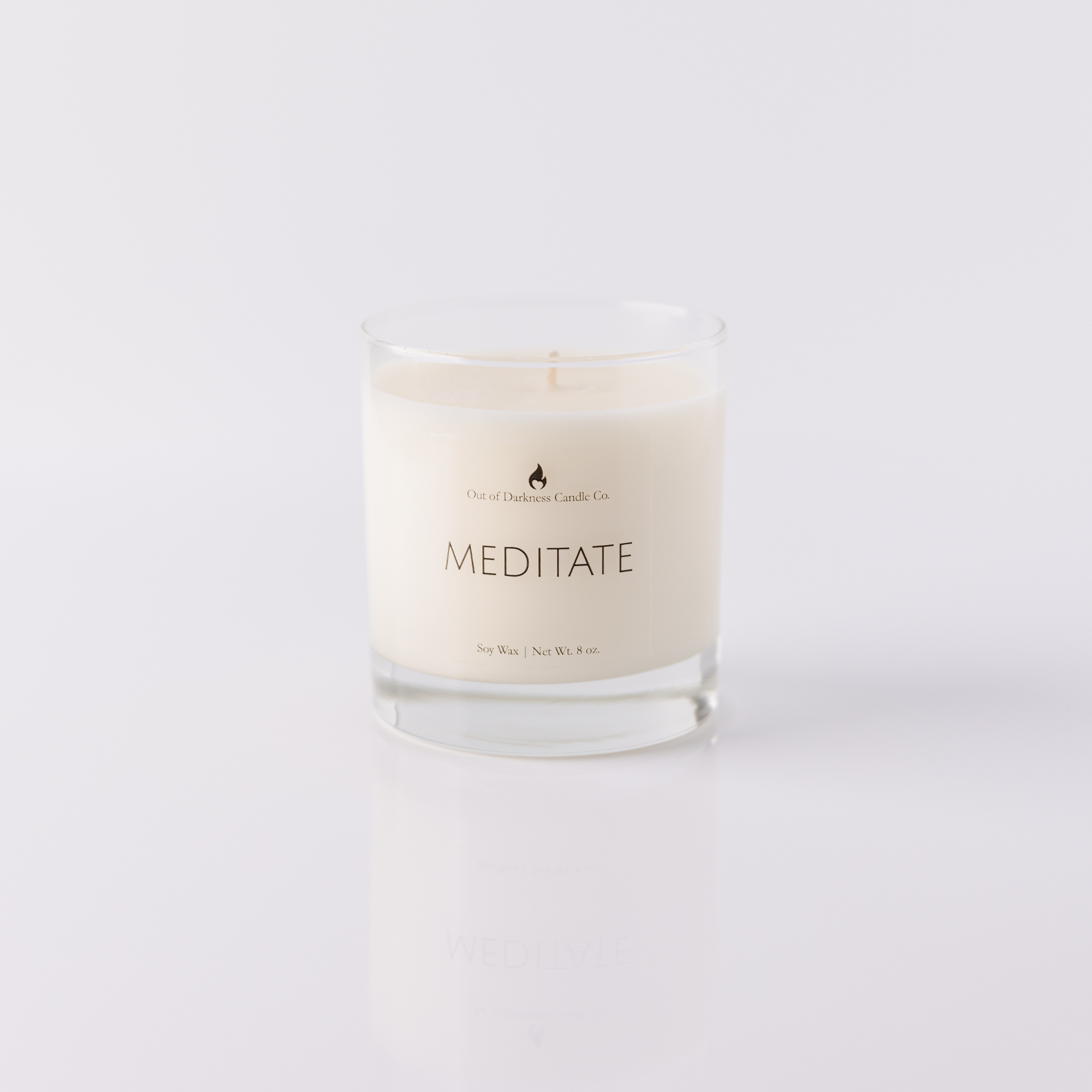 Glass Jar Candle says meditate all white background
